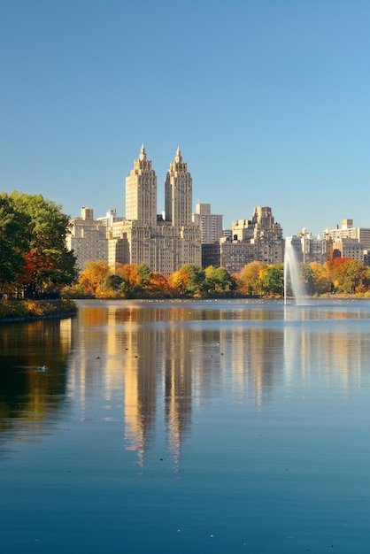 Skyline with apartment skyscrapers over lake with fountain in Central Park in midtown Manhattan in New York City