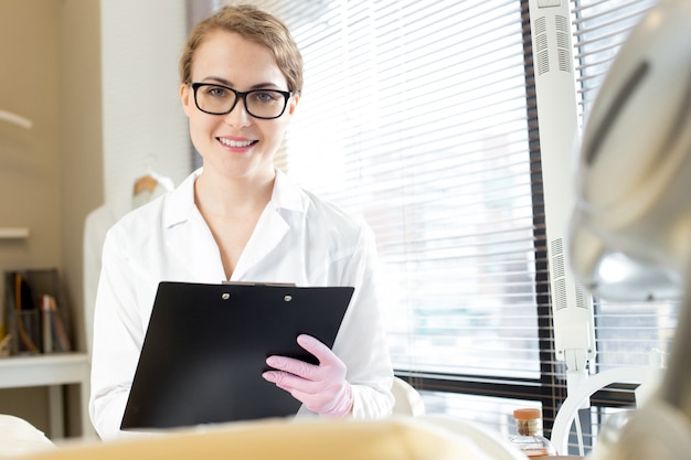 Smiling Cosmetologist Holding Clipboard