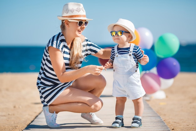 smiling mom with cute baby boy outdoors