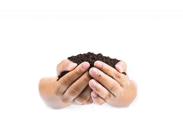 Photo soil in hands on white background