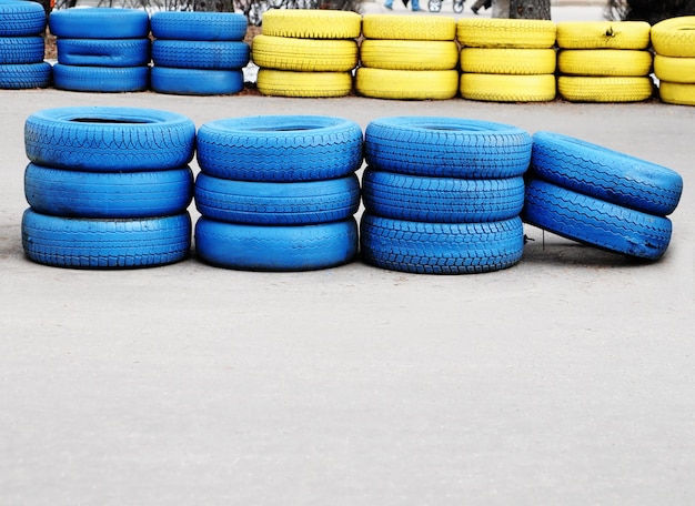 A stack of blue tires are stacked up in a row.