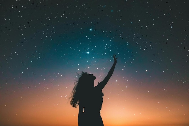 Starry sky with a woman reaching up to the stars