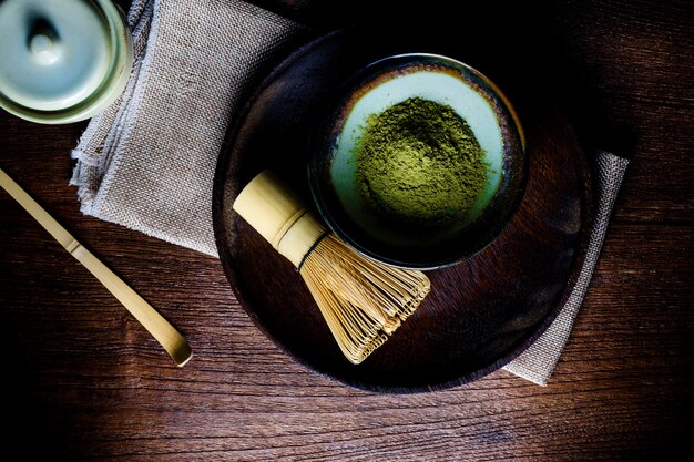 Still life with green tea and Japanese wire whisk made of bamboo for tea ceremony