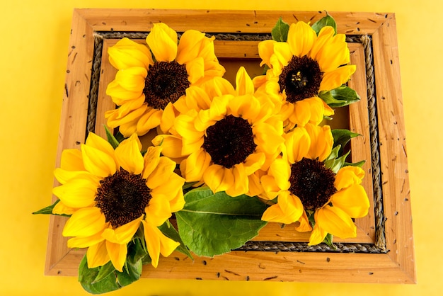 Sunflowers inside a wooden frame