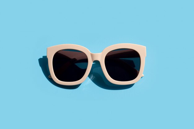 Sunglasses on blue background. Enjoy holiday concept.