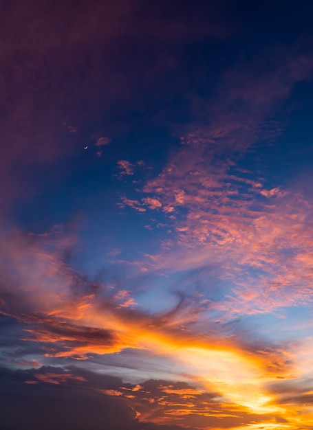 Sunset sky vertical with majestic colorful sunlight in the evening on peaceful twilight, dusk sky.