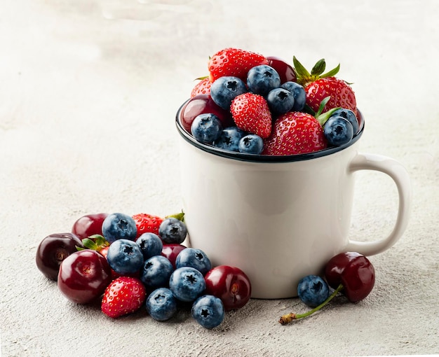 Sweet berries in cup on concrete backgrounds