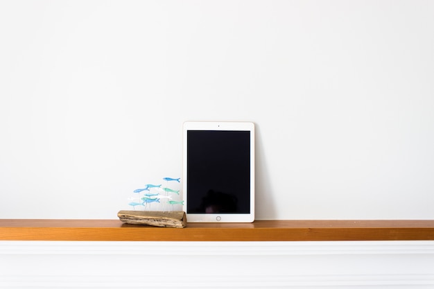 Tablet with blank screen on wood