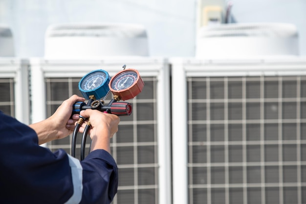 Technician is checking air conditioner measuring equipment for filling air conditioners service and maintenance air conditioner