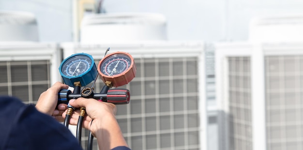 Technician is checking air conditioner measuring equipment for filling air conditioners service and maintenance air conditioner