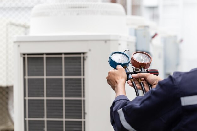 Technician is checking air conditioner measuring equipment for filling air conditioners