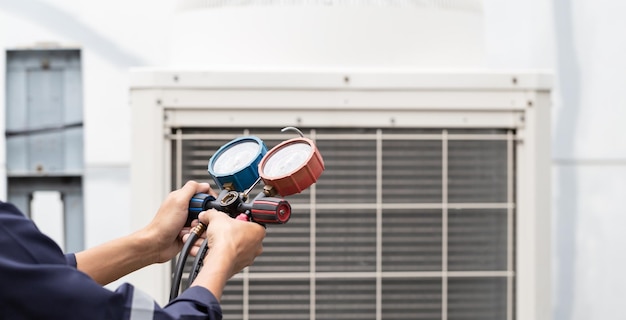 Technician is checking air conditioner measuring equipment for filling air conditioners