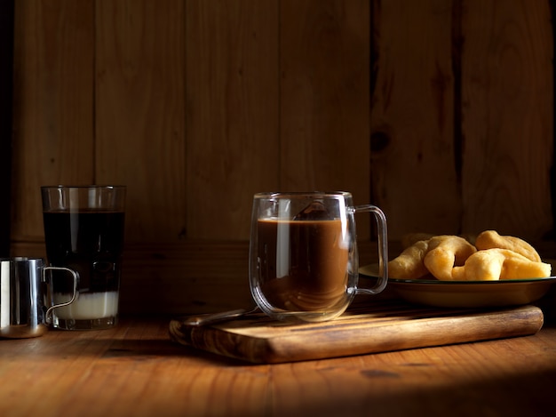 Photo thai style breakfast with hot coffee and deep fried dough sticks on wooden table