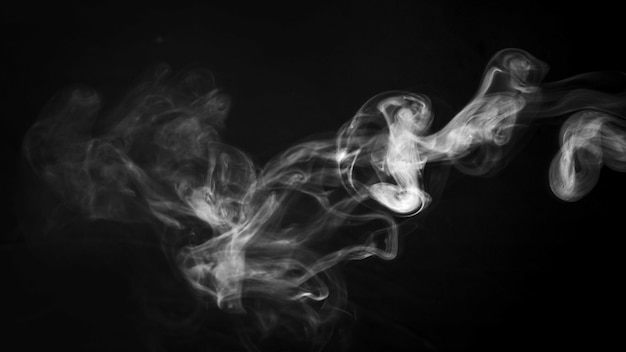 A thick twirling smoke pattern in front of black background