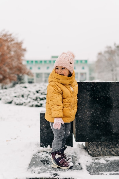 Toddler girl happy with snow day in winter.