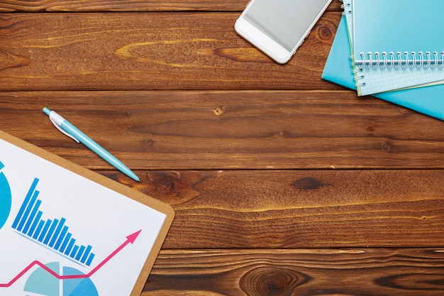 Top view of business paper chart or graph on wooden table