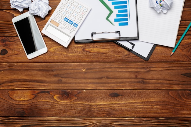 Top view of business paper chart or graph on wooden table