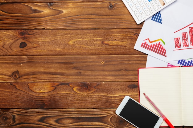 Top view of business paper chart or graph on wooden table