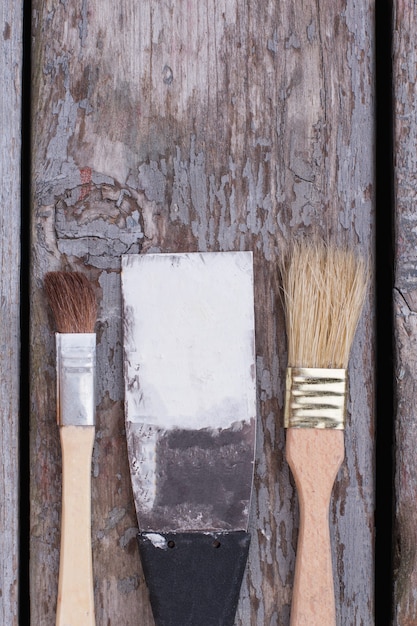 Top view of construction tools on wooden background