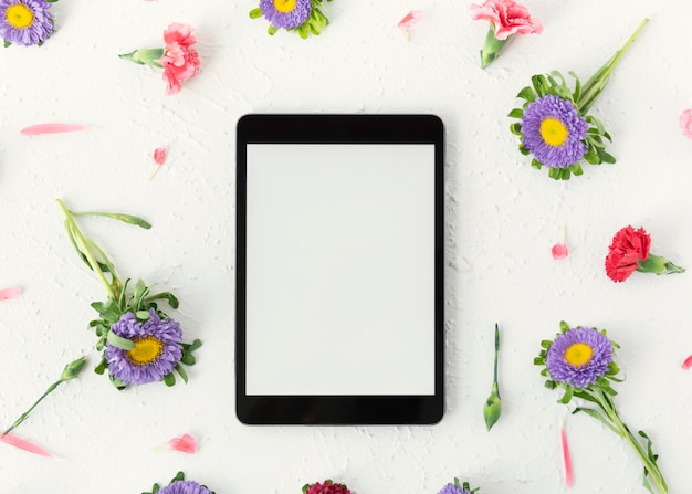 Top view digital tablet copy space surrounded by flowers