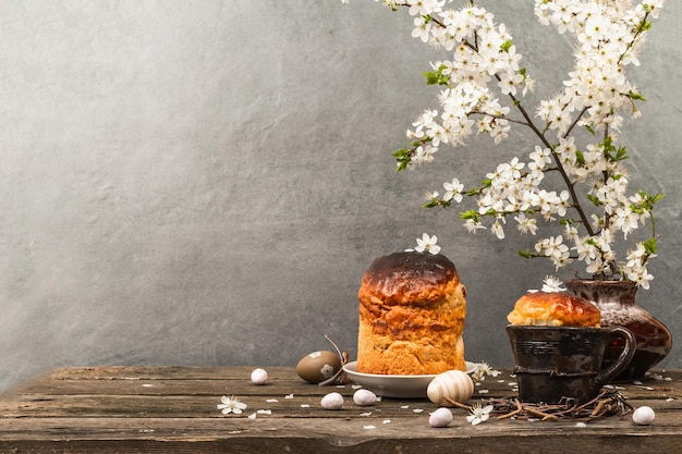 Traditional Easter cake in a rustic style Vintage baking pot blooming cherry plum branches Wooden background