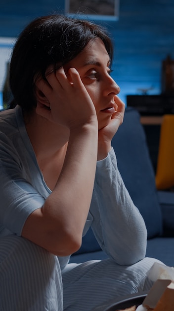 Unhappy, depressed, frustrated, psychotic alone woman sitting on couch feeling disappointed