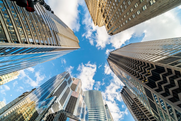 Uprisen angle with fisheye scene of Downtown Chicago skyscraper with reflection of clouds among high buildings