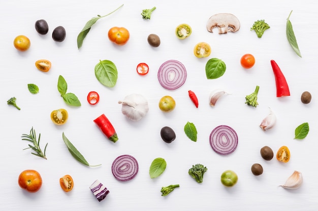 Various fresh vegetables and herbs on white background