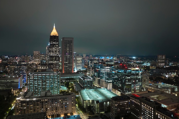 View from above of brightly illuminated high skyscraper buildings in downtown district of Atlanta city in Georgia USA American megapolis with business financial district at night