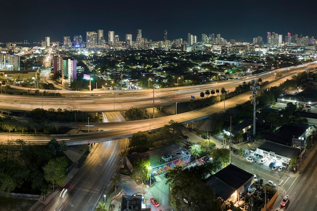 Above view of wide highway crossroads in Miami Florida at night with fast driving cars USA transportation infrastructure concept