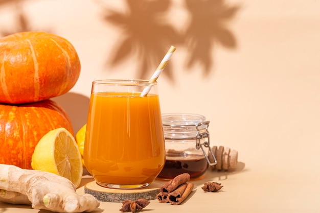 Vitamin pumpkin drink with ginger honey and lemon Autumn pumpkin juice copy space for text