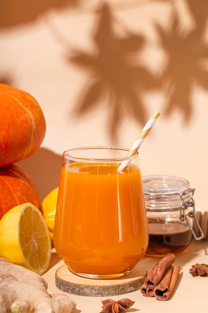 Vitamin pumpkin drink with ginger honey and lemon Autumn pumpkin juice vertical photo