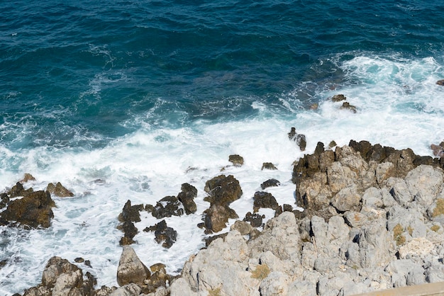 Waves crash on the rocky beach forming splashes Waves and splash on the beach