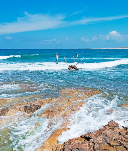 Waves over Is Arutas rocky shore