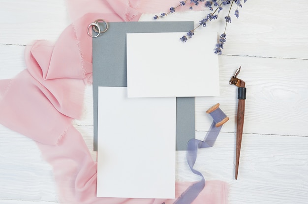 White blank cards with wedding rings and pink fabric with lavender flowers