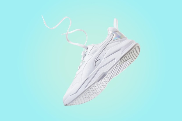 White flying sneakers on blue and yellow gradient background