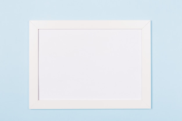 White frame empty blank picture on light blue background .