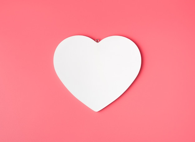 White heart on pink background.