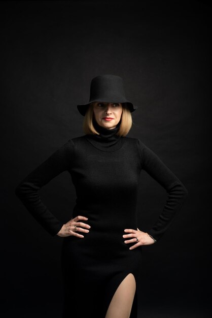 Woman in black dress and black hat