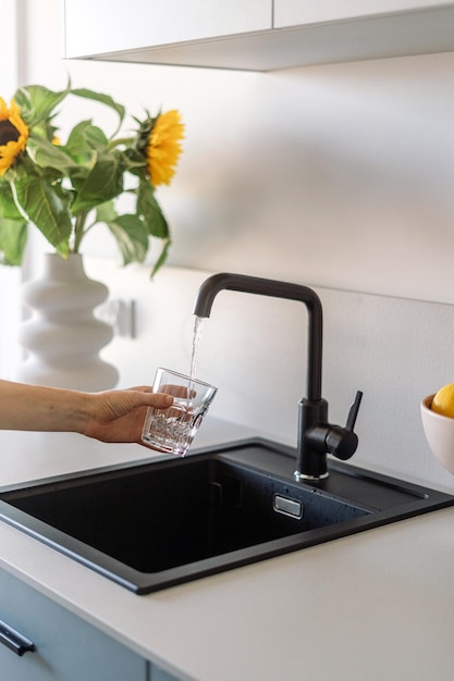 Woman hold glass of clear and mineral filtered water