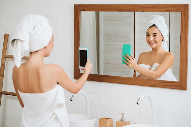 Woman taking selfie on smartphone