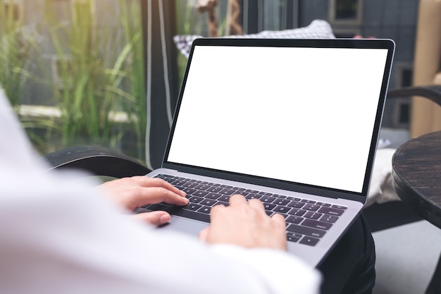 Woman touching and typing on laptop