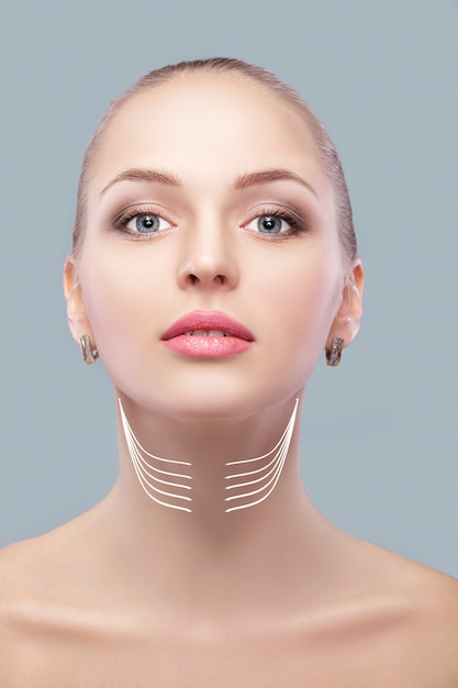 Woman with arrows on face neck lifting concept. correction of double chin