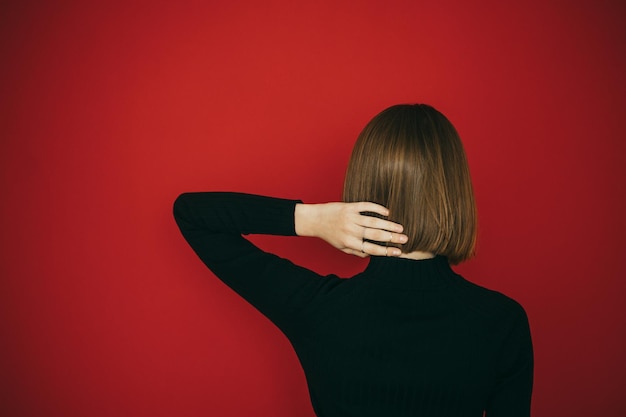 Woman with bob hairstyle isolated on red Background Copy space