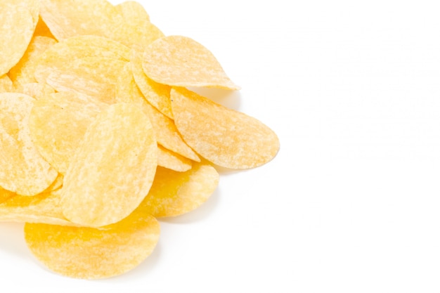 Yellow potato chips isolated on white