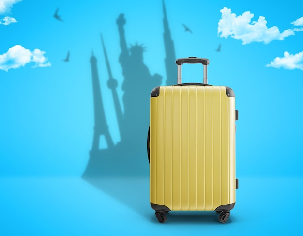 Yellow suitcase with travel dreams on blue background travel concept