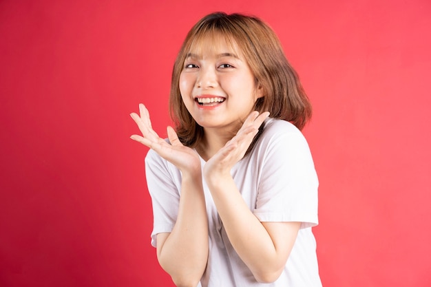 Photo young asian girl with cheerful gestures and expressions on pink