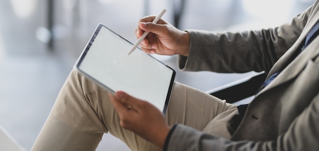 young businessman working on his project while using digital tablet