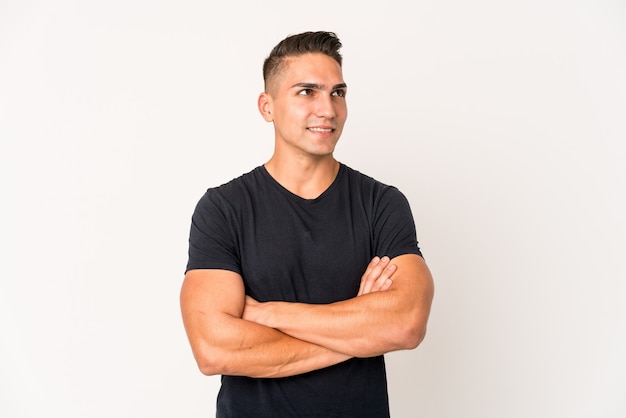 Young caucasian handsome man isolated smiling confident with crossed arms.