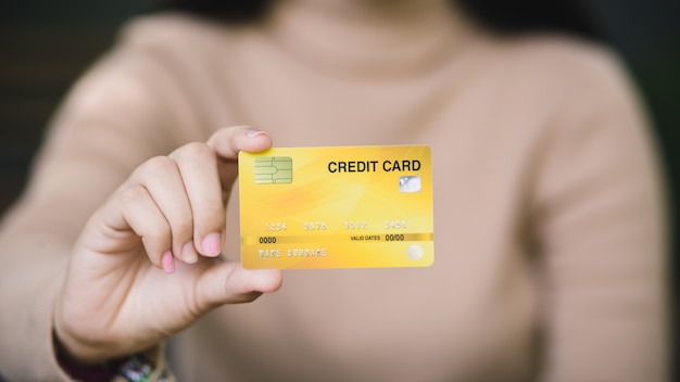 Young female holding credit card